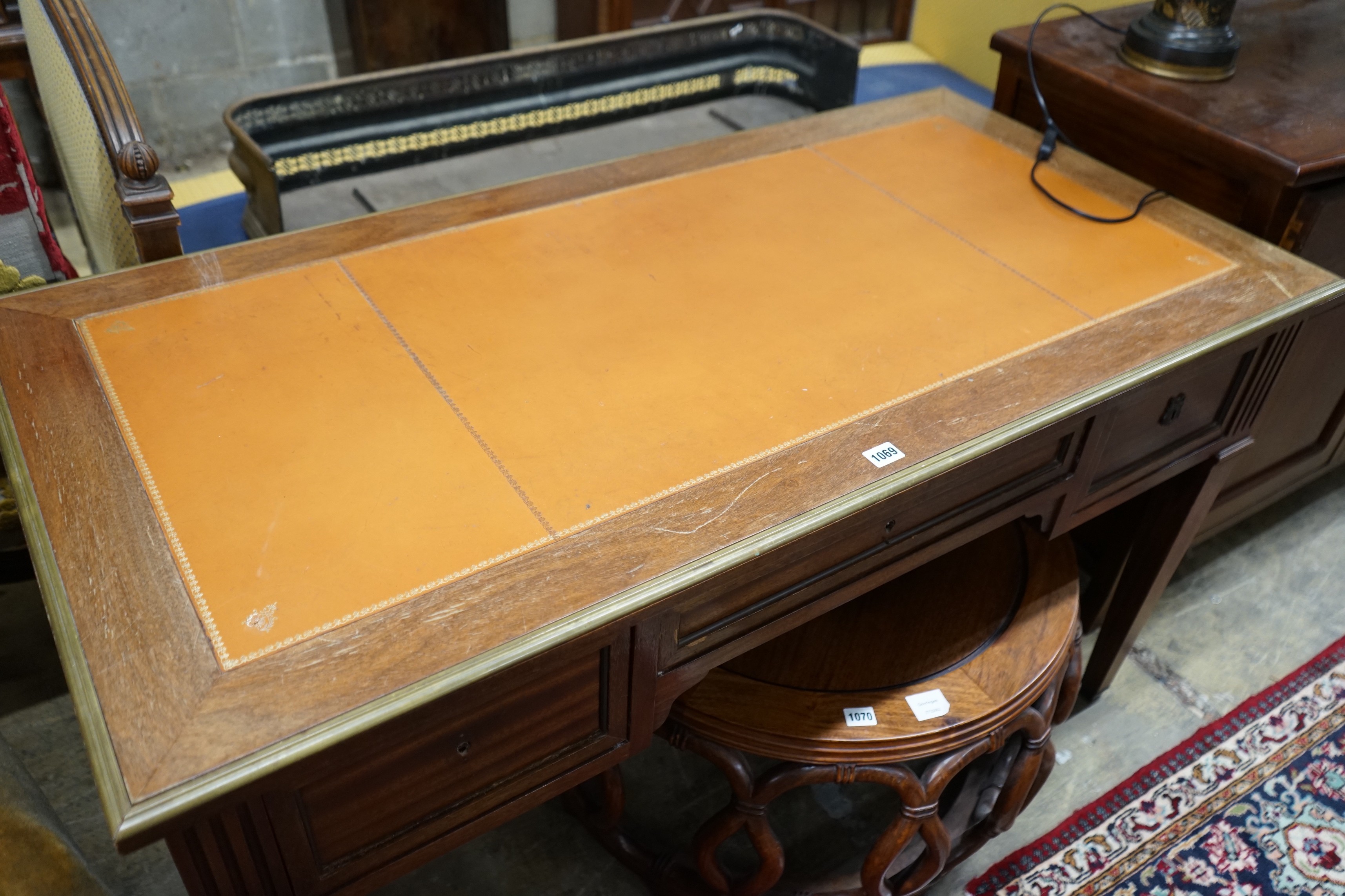 An Empire style brass mounted mahogany kneehole desk, width 130cm, depth 66cm, height 76cm